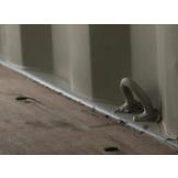 Fitted at the bottom of a container side wall